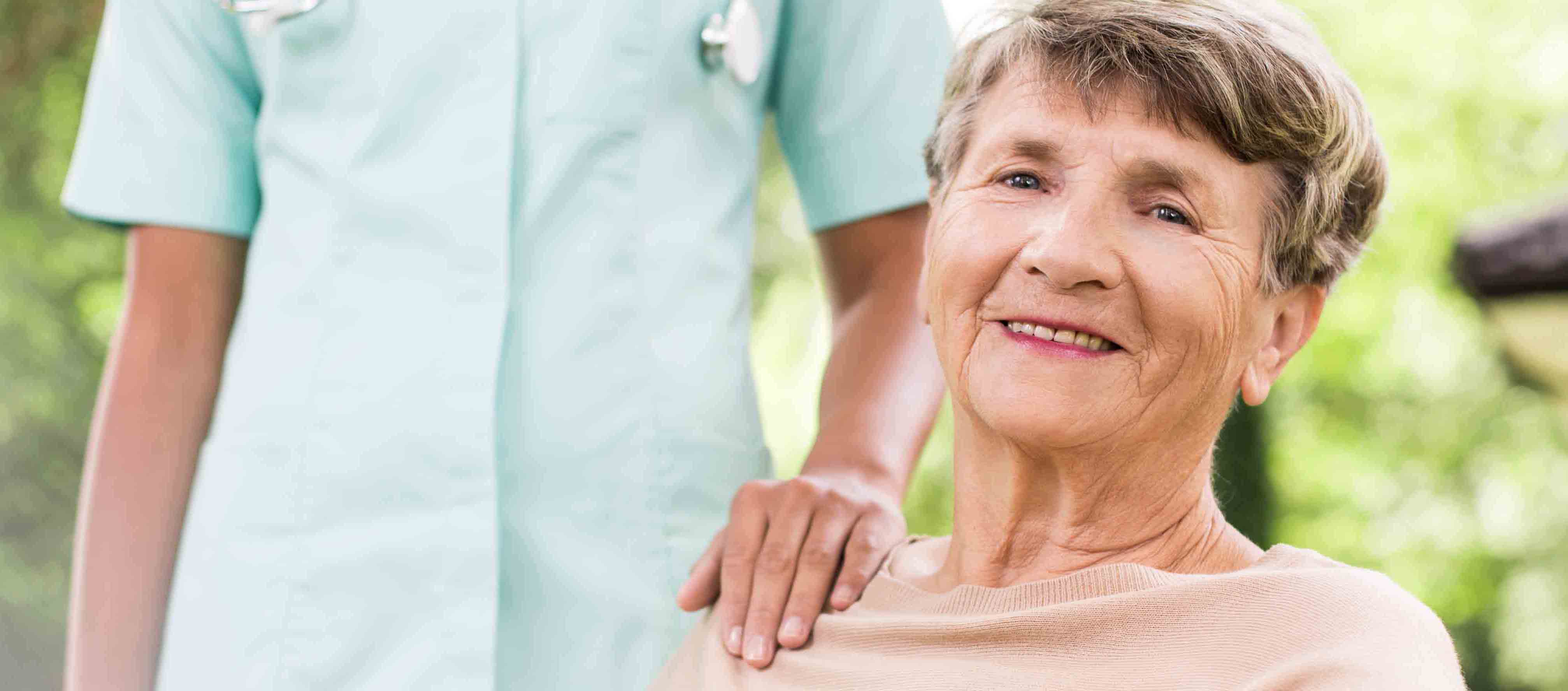 A Stockwellcare carer supporting a service user outdoors
